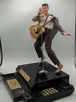 Full view of TeleMania Elvis Presley telephone with base, handset, statue and keypad