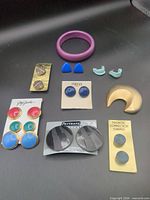 All items laid out showing variety of earrings and bangle