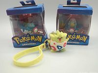 Front view showing two boxed ornaments and Togepi keychain