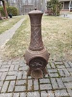 Full view of cast iron chiminea on patio