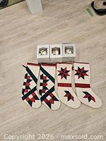 Four quilted stockings and three boxed ornaments laid out