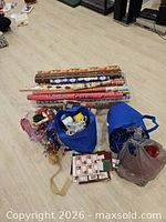 Full lot showing wrapping paper rolls, two bags with ribbons and bows, gift tags