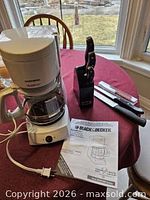 Coffee maker, carafe, cord, manual, knife block, knives on table