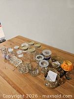 Group of mason jars, assorted candle holders, ceramic eggs and dishes