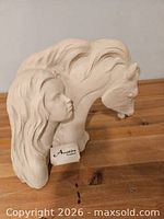 Front angled view of Austin sculpture showing girl and horse heads