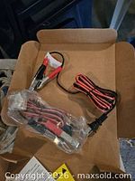 Cable with battery clamps and SAE connector in plastic wrap