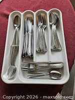 Tray holding full stainless steel flatware set