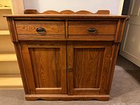 Front view showing drawers, doors, backsplash, overall style