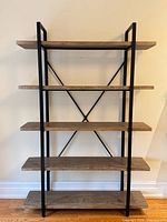 Front view of shelving unit showing five shelves and metal frame