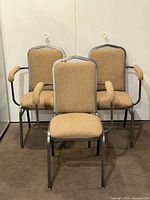 Front view of three stacked armchairs showing design and upholstery
