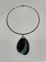 Full view of silver-tone choker with attached agate pendant