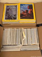 Open box showing two stacks of National Geographic magazines