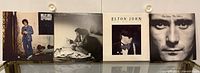 Front covers: Billy Joel, unidentified Springsteen album, Elton John Ice on Fire, Phil Collins Face Value