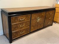 Front left angle of dresser showing drawers, cabinet, pulls, top surface