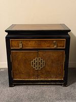 Front view showing drawer, doors, brass hardware, finish wear