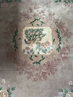 Central peacock cartouche with surrounding floral wreath