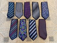 Nine ties laid flat showing full designs