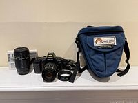 Full lot: camera with lens, second lens, manuals, strap, filter ring, Lowepro case