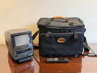 Front view of Sony DT1 monitor, carrying case, remote