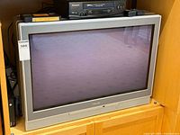 Front view of Toshiba CRT television with remote on top