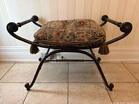 Full view of wrought iron bench with cushion