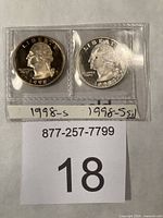 Both proof quarters in flip, obverse view with handwritten labels