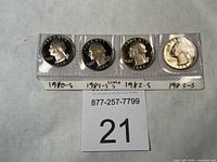 Front view of four proof Washington quarters in plastic sleeves labeled 1980-S, 1981-S, 1982-S, 1983-S