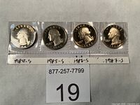 Front view of all four proof quarters in plastic sleeves