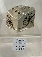 front view showing floral decoration and stem holes