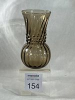 Full front view of smoky green optic swirl glass vase