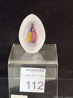 Full view of egg-shaped paperweight on display stand