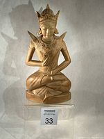 Front view of entire wooden Arjuna sculpture