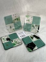 Group shot showing all four fused glass coasters with lot card