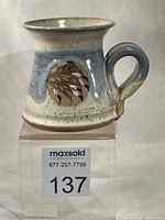 Front view of mug showing flower motif and handle