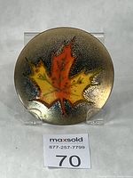 Front view of enamel maple leaf dish on stand
