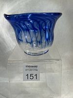 Front view showing cobalt blue ribbon swirl pattern and flared rim