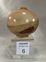 Front view of lathe-turned Garry oak vase on display stand