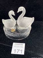 Front view showing both frosted swans and RCR sticker on clear base
