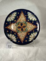 Front view of Talavera plate on stand showing full design