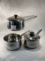 Group shot of three saucepans with two lids