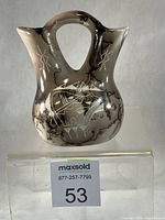 Front view of double-spout horsehair wedding vase with bear carving