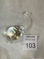 Top view of clear glass mouse showing curved tail and body