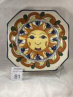 Front view of octagonal Talavera plate showing full design and chips on rim