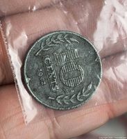 Obverse of 1942 Netherlands 10 cents coin in plastic bag