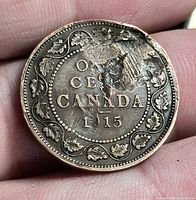 Reverse of 1915 Canada large cent with leaf wreath and visible damage at 1-2 o’clock