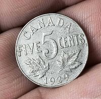 Reverse of 1929 Canada 5-cent coin showing CANADA FIVE CENTS maple leaves and date