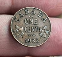 Reverse of 1933 Canada one cent coin showing maple leaves and date
