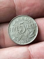 Reverse of 1936 Canada 5 cent coin showing denomination, maple leaves and date
