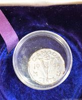 Reverse of 1945 Canada V nickel in capsule