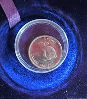 Reverse side showing rabbit design and CANADA 1867-1967 legend inside capsule on blue background